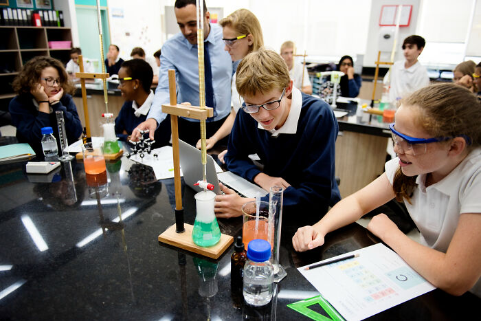 High school students conducting a science experiment in a classroom lab
