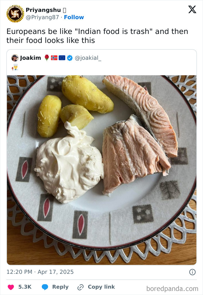 Boiled potatoes, salmon, and a large dollop of sour cream on a plate