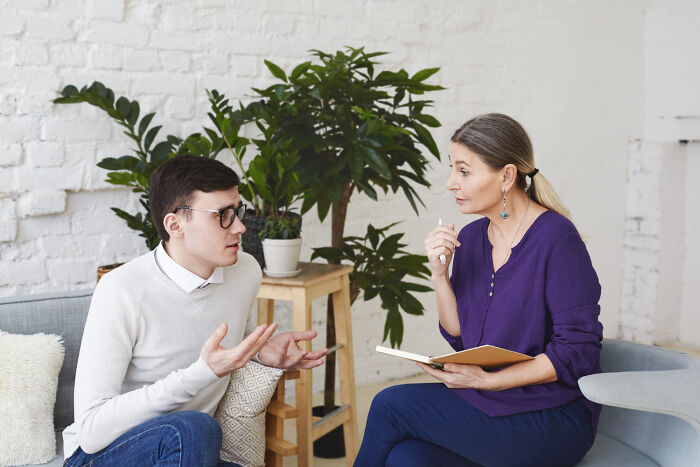 Therapist listening to patient during psychiatric counseling session