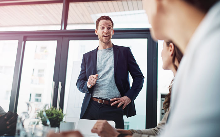 Businessman confidently presenting to a team about AI