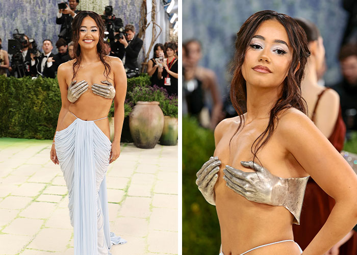 Smiling celeb on a red carpet in a Met Gala outfit featuring extra hands, a silver bustier, and a draped skirt.