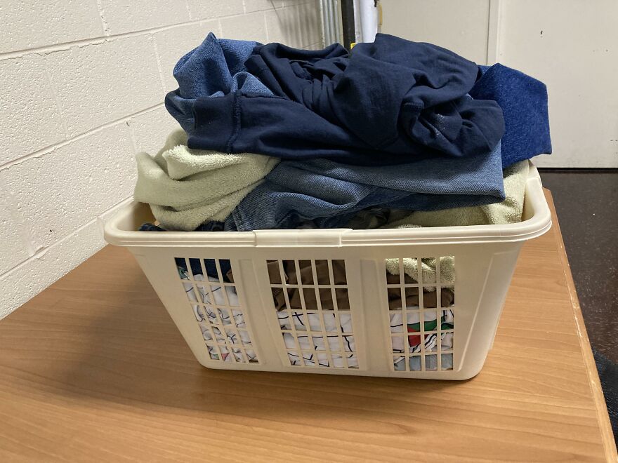 A laundry basket overflowing with clothes, symbolizing the daily stressors that can feel like one of the most stressful jobs.