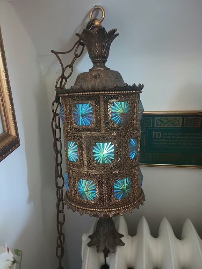 Ornate vintage secondhand hanging lamp with blue glass panels and metal filigree