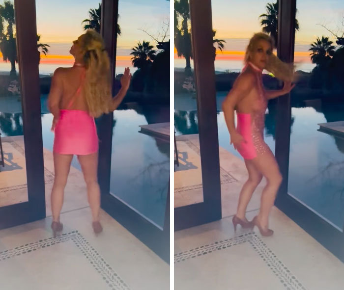 Britney Spears dancing in a pink dress with a sunset pool background