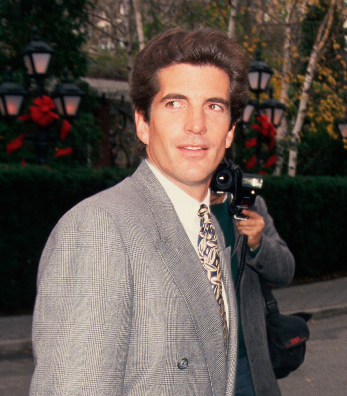 Portrait of JFK Jr. in a grey suit outdoors Portrait of JFK Jr. in a grey suit outdoors