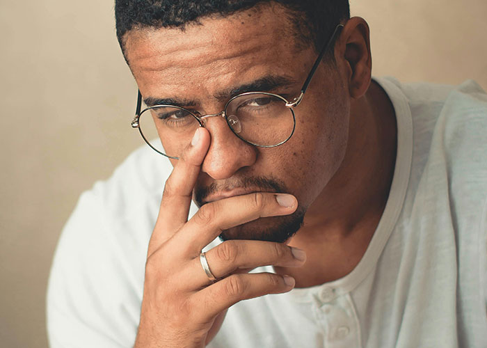 Pensive man with glasses deep in thought about mysterious disappearances