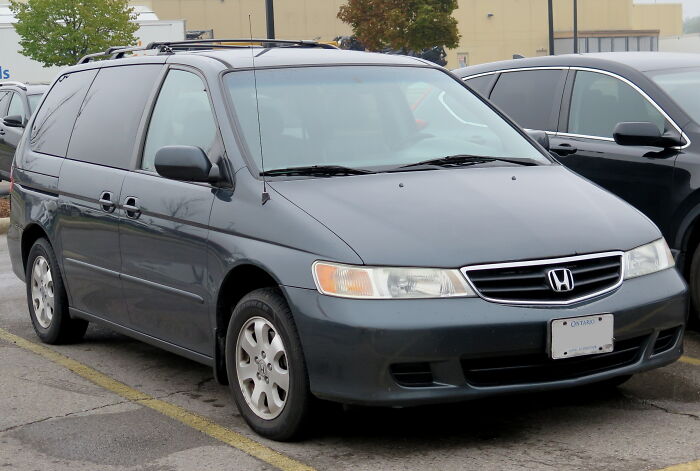 A dark gray Honda Odyssey minivan, parked in a lot, with Ontario license plates. Disturbing d***h stories.