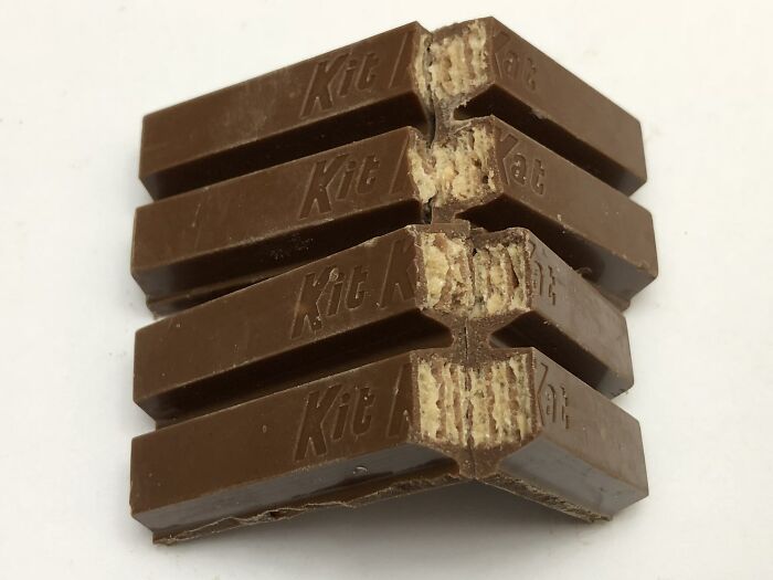 Stacked Kit Kat chocolate bars with one bitten