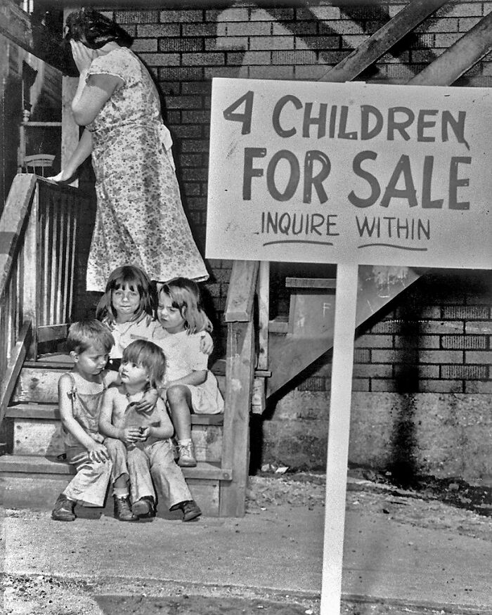 Vintage black and white image of children with a creepy for sale sign