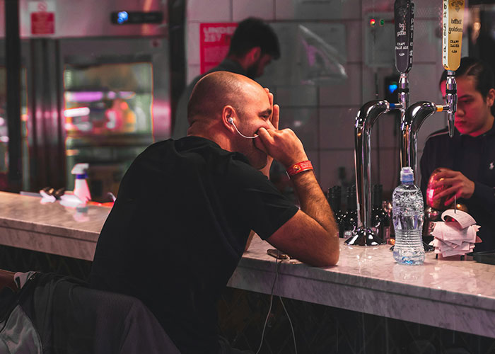 Man sitting alone at bar looking contemplative related to mysterious vanishings