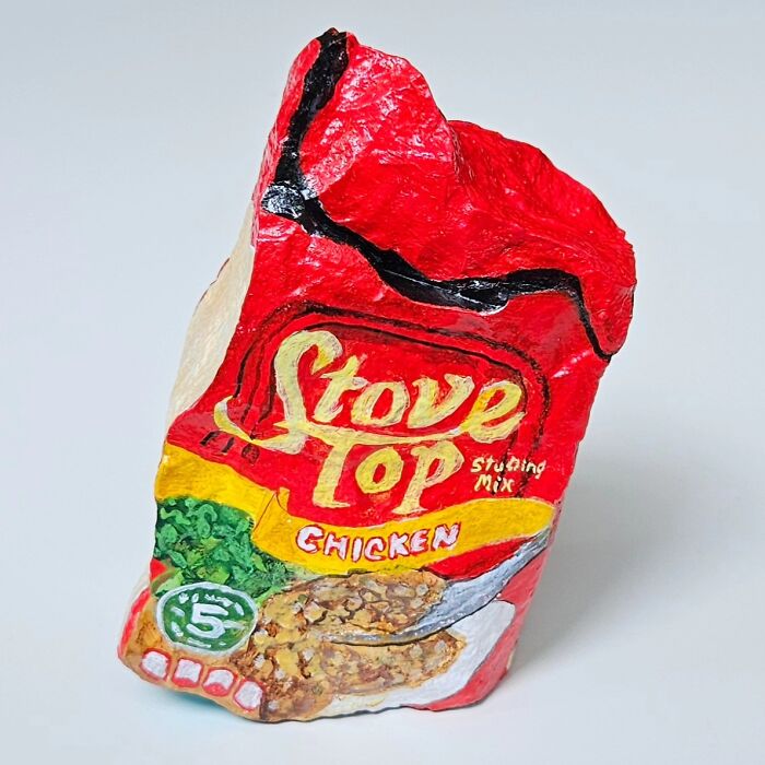 A colorful stone creation painted to look like a box of Stove Top Chicken Stuffing Mix, transforming rocks into iconic foods.