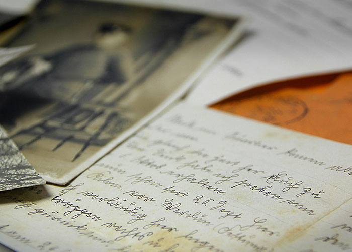Old letters and photographs depicting forgotten memories in disappearances