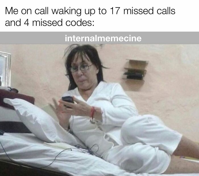 A medical professional, disheveled and in bed, checking her phone after 17 missed calls and 4 missed codes. Medical memes.