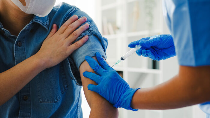 Person receiving vaccine injection from healthcare worker