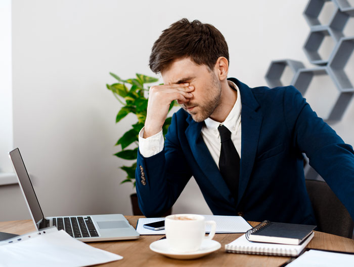 Stressed manager in office frustrated with AI integration challenges
