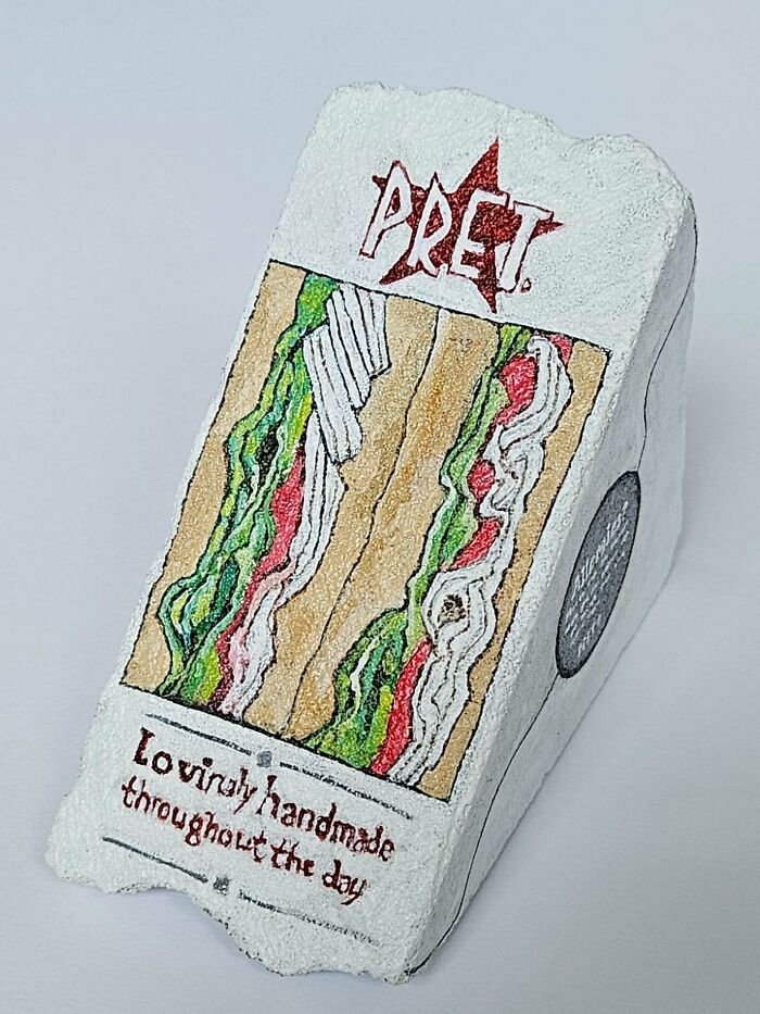 A colorful stone creation, a rock painted as a Pret A Manger sandwich, showcasing iconic food art.