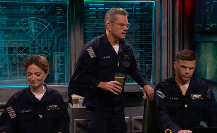 Matt Damon in a gross SNL sketch. He's dressed in a US Navy uniform, holding a green smoothie, with two other actors.