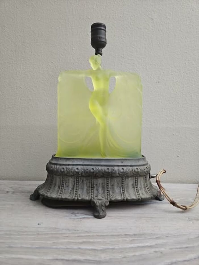 Art deco vintage secondhand lamp with green frosted glass figure on ornate metal base