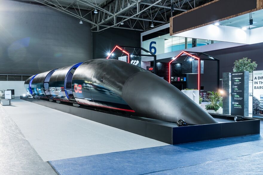 Prototype of a sleek hyperloop transportation pod showcased at a tech exhibition
