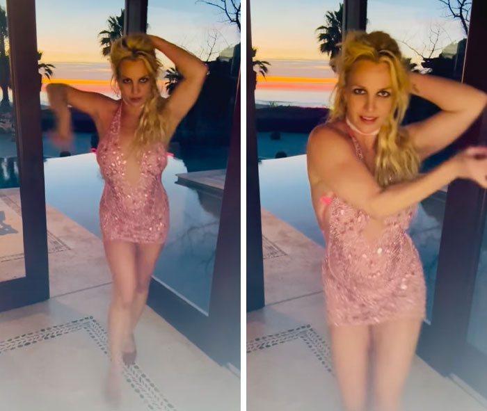 Britney Spears performing a dance in a pink dress at sunset