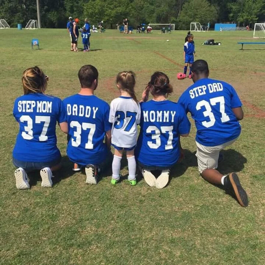Family photo of stepmom, dad, child, mom, and stepdad wearing matching soccer jerseys showing unity in co-parenting Family photo of stepmom, dad, child, mom, and stepdad wearing matching soccer jerseys showing unity in co-parenting