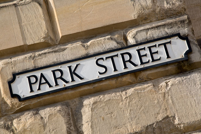 Stone wall with a Park Street sign in European city
