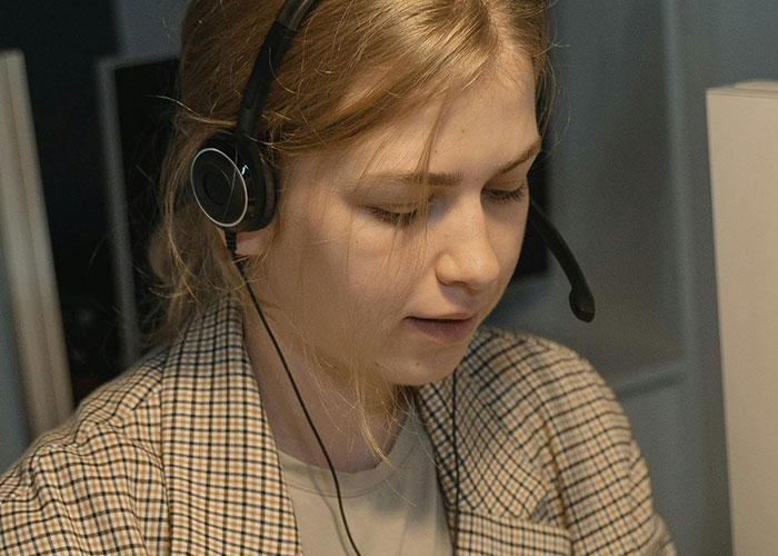 Young woman wearing headset working in a call center.