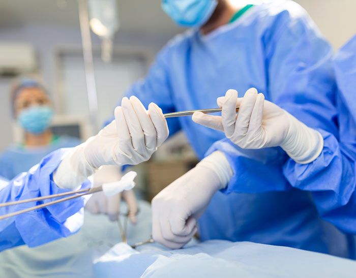 Surgeons performing an operation with surgical tools in a sterile environment