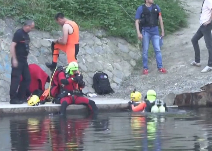 Rescue divers preparing at water site during chilling discovery in France investigation