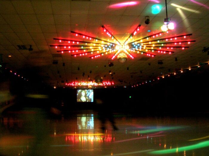 Colorful disco lights reflecting on the floor in an eerie skating rink