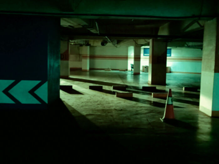 Dark underground tunnel with yellow water under brick arch in backrooms levels