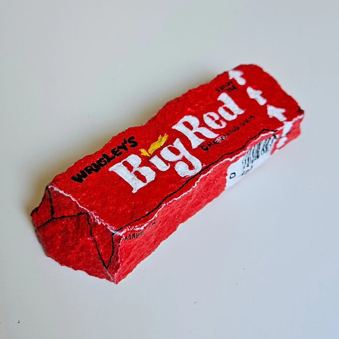 A stone creation painted like a Wrigley's Big Red chewing gum pack, turning rocks into iconic foods and famous products.
