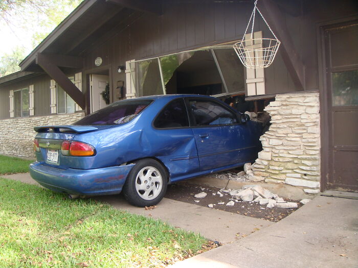 Car crashed into house wall, example of laziness preventing disaster