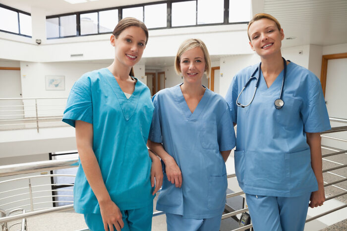 Group of smiling nurses in psychiatric facility uniforms