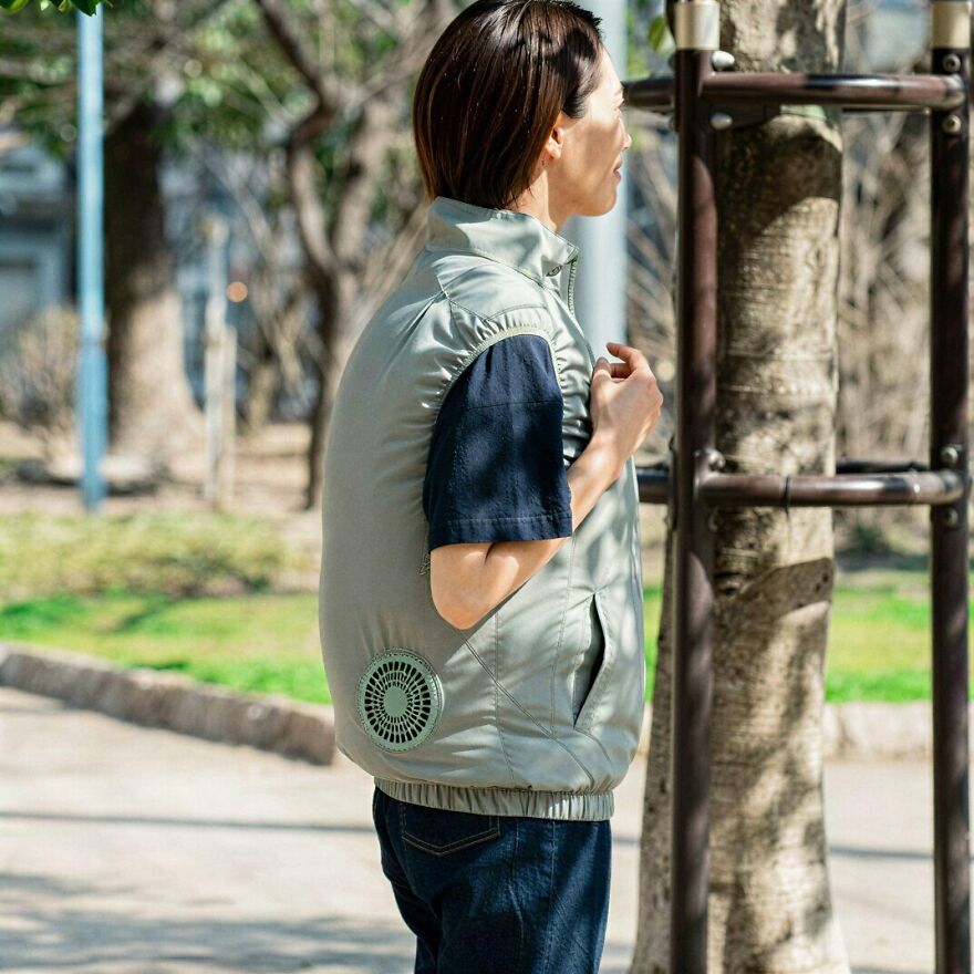 Person outdoors wearing a Japanese cooling vest with a visible fan. These Japanese things are innovative.