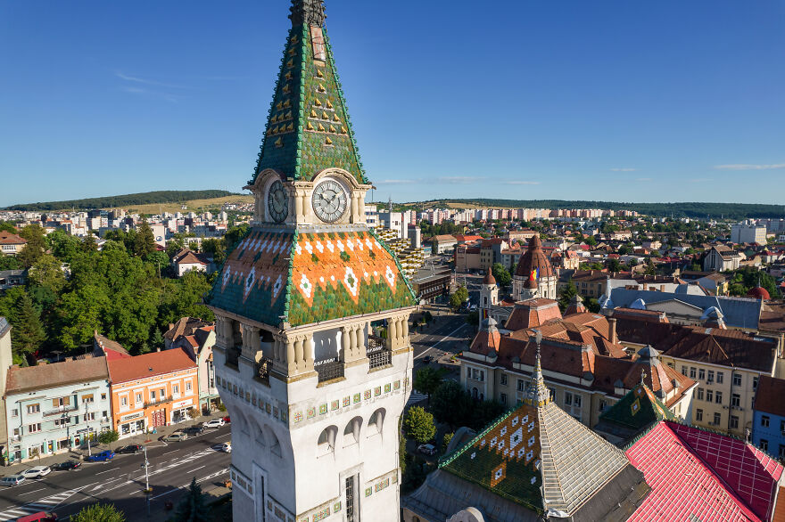Historic clock tower with patterned roof in small European country
