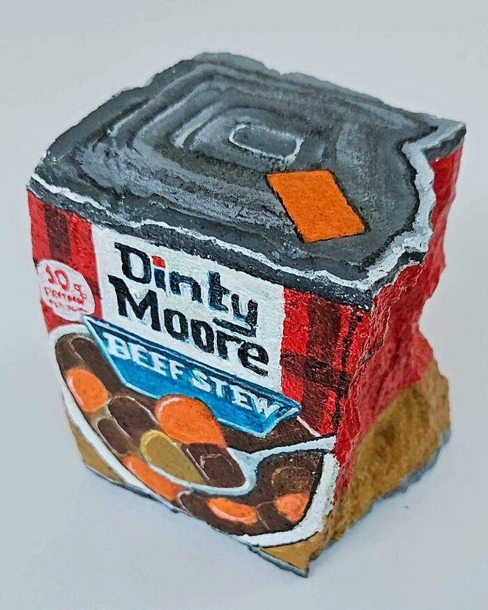 A colorful stone creation painted to look like a Dinty Moore Beef Stew can, turning rocks into iconic foods.