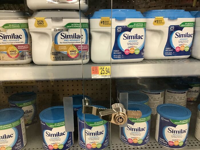 Baby formula locked behind a glass door in a grocery store, reflecting economic struggles that can lead to deeply immoral actions.