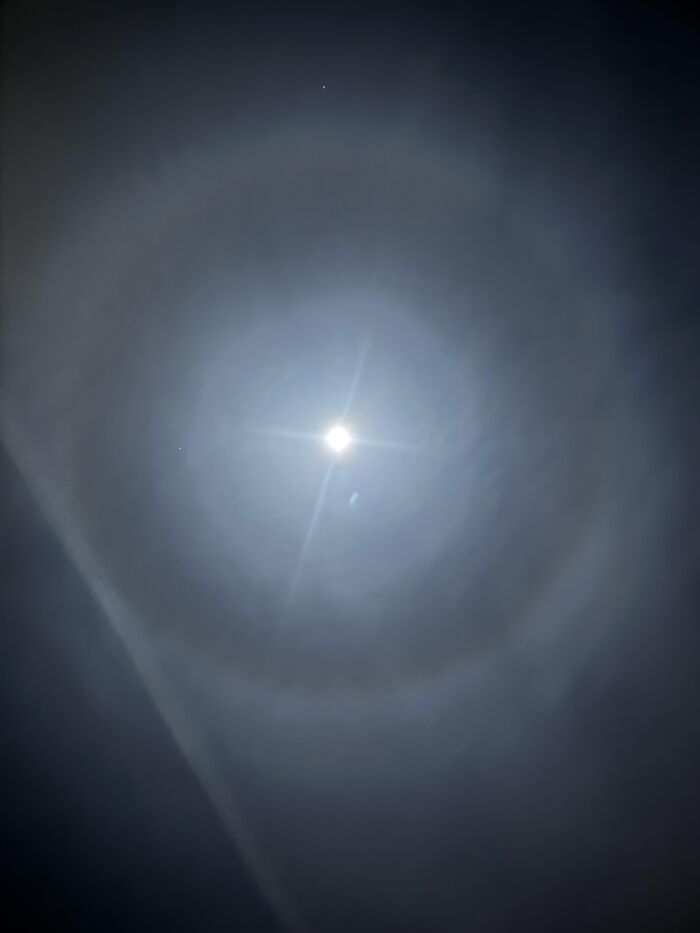 Moon halo glowing bright in night sky rare moments photo