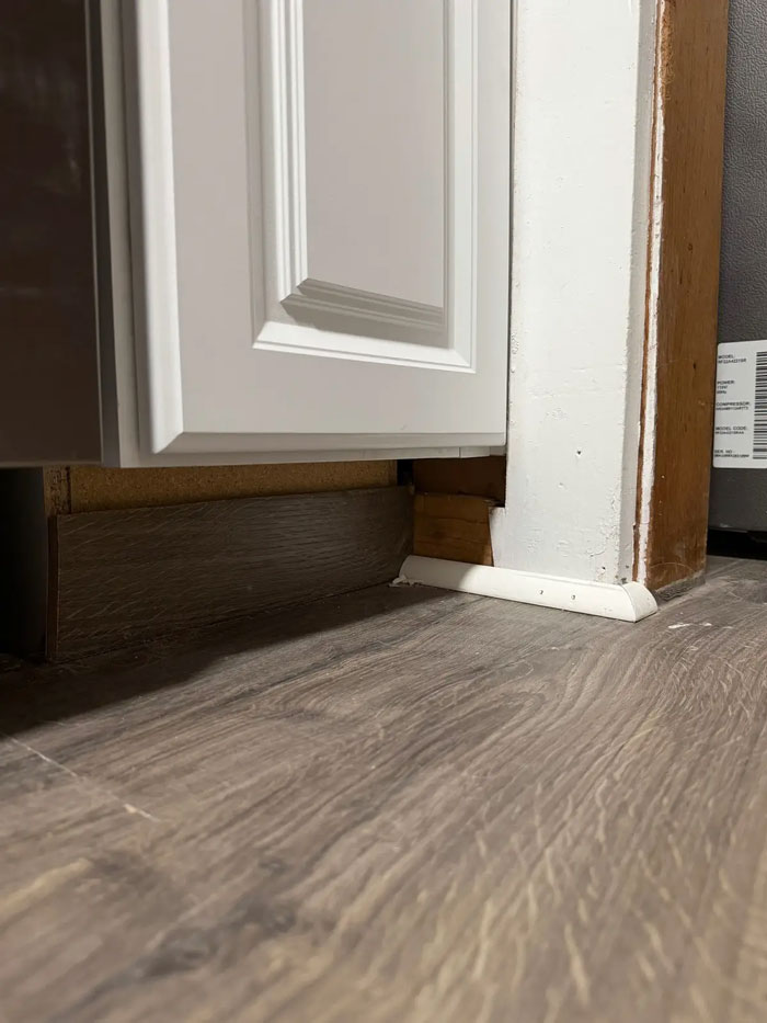 Poorly installed baseboard and trim by a very expensive contractor, leaving gaps and unfinished edges, a disappointing outcome.