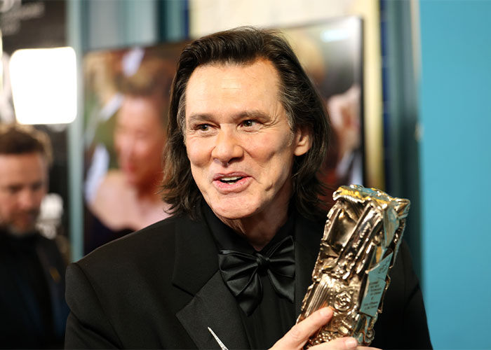 Male celebrity holding award, illustrating unrecognizable male celebs