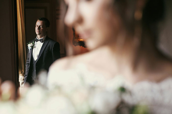 Groom looking at bride with a serious expression on wedding day