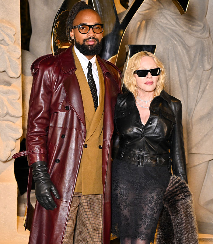 Madonna and a man posing in leather outfits at a fashion event Madonna and a man posing in leather outfits at a fashion event