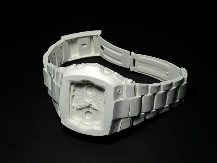 Paper sculpture of a wristwatch with detailed links and face