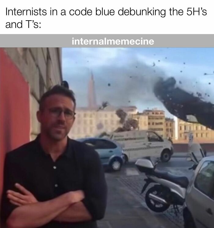 Ryan Reynolds looking calm amidst a city destruction scene, perfect for medical memes for doctors and nurses.
