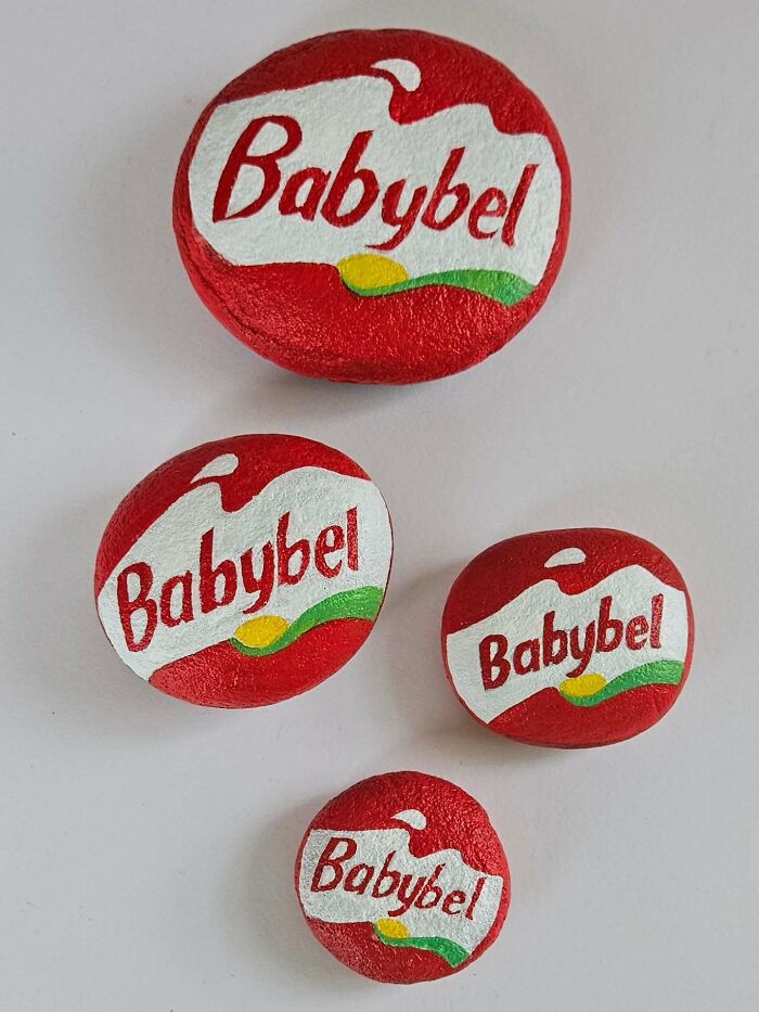 Four colorful stone creations, painted like Babybel cheeses, turning rocks into iconic foods and famous products.