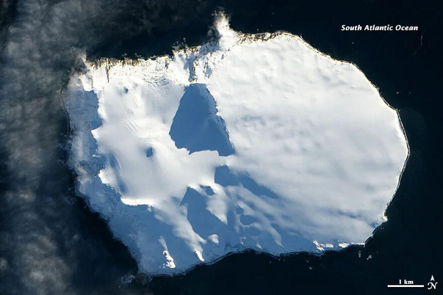 Aerial view of a snow-covered island in the South Atlantic Ocean, one of the most isolated places on Earth.