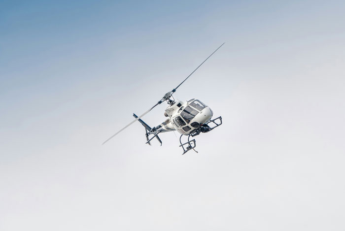 White helicopter flying, representing PR crisis events
