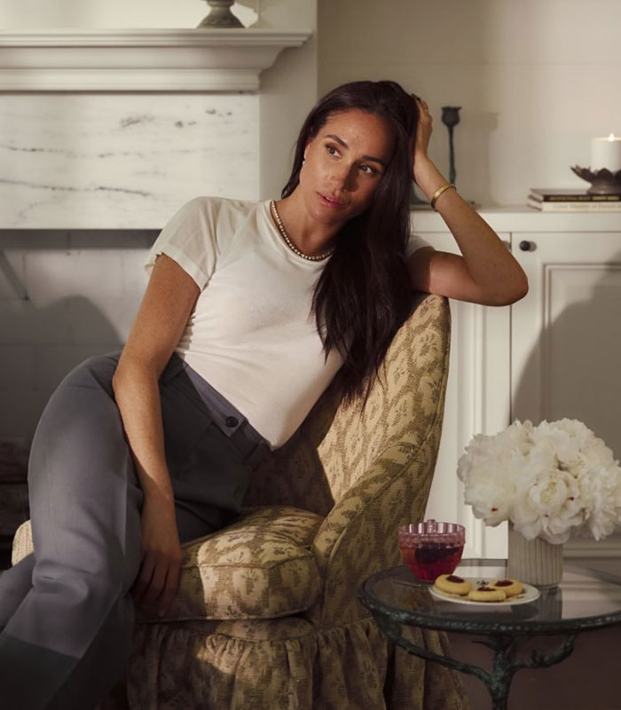 Meghan Markle seated in chair looking pensively during online safety campaign photo shoot