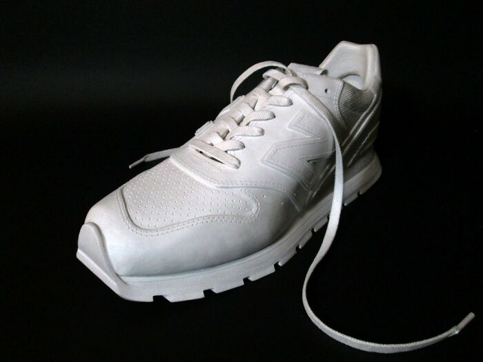 Realistic paper sneaker with detailed stitching and laces